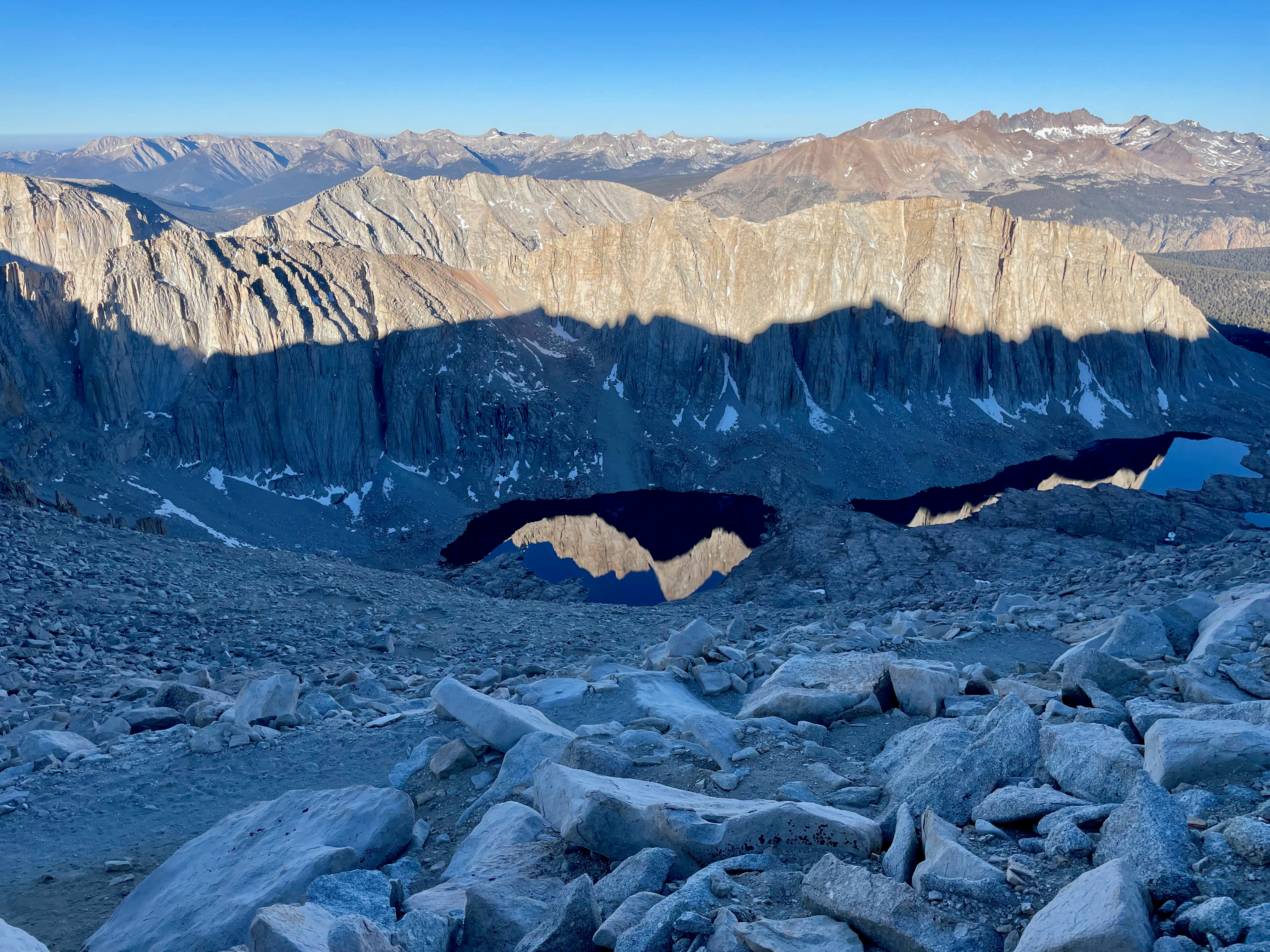 a view of a mountain range from a rocky area