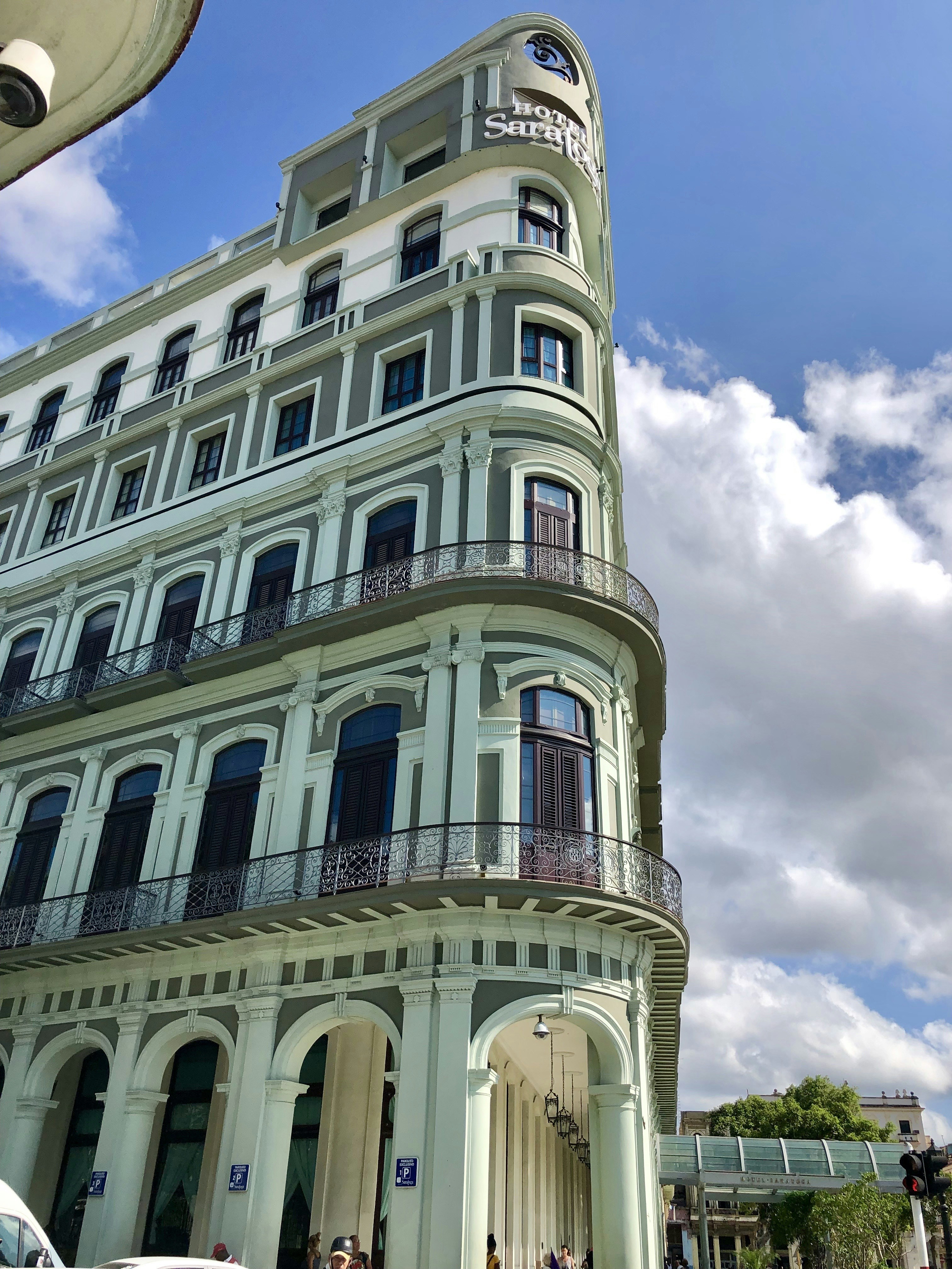a tall white building with balconies and balconies