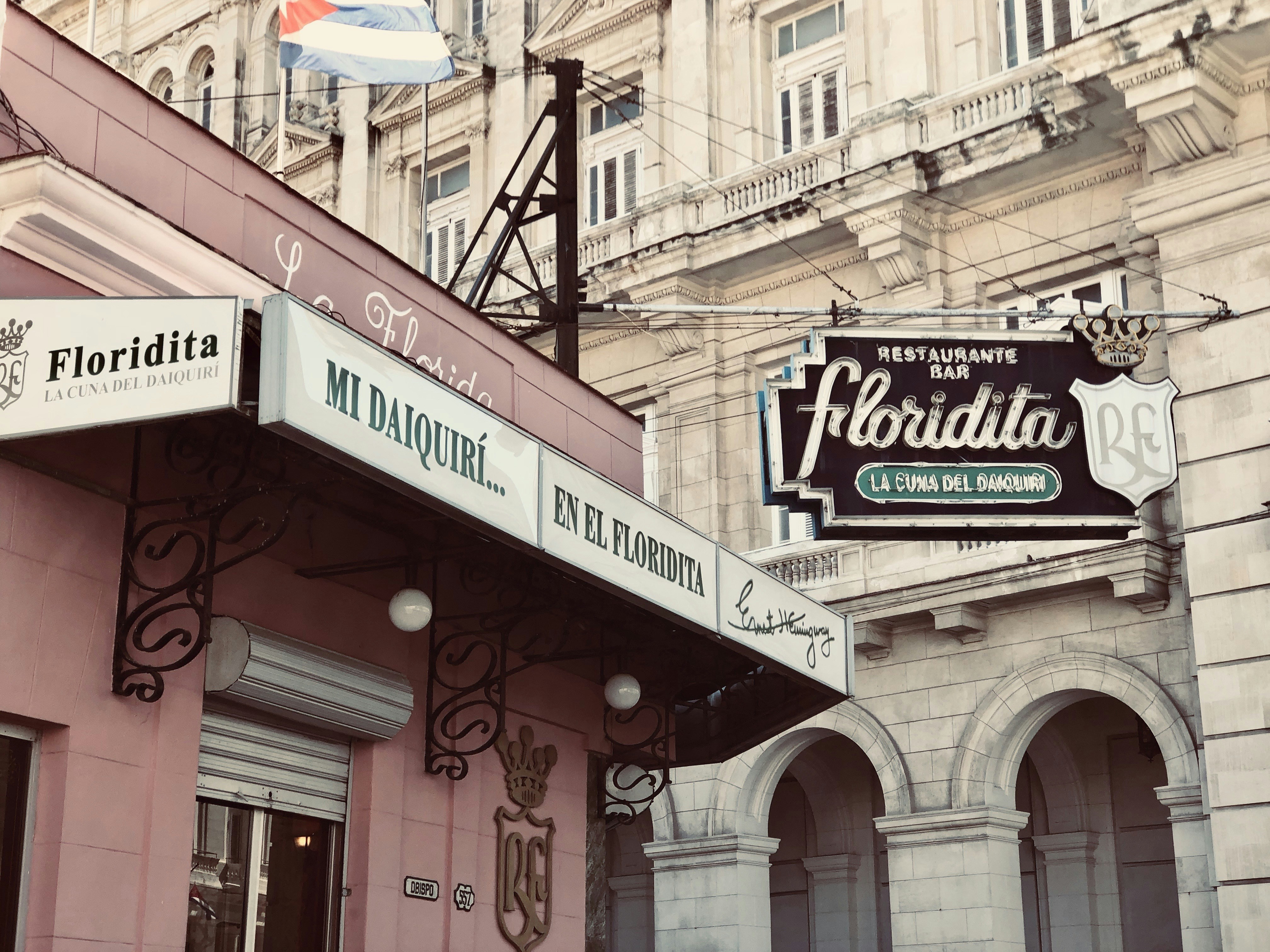 a pink building with a sign for a restaurant
