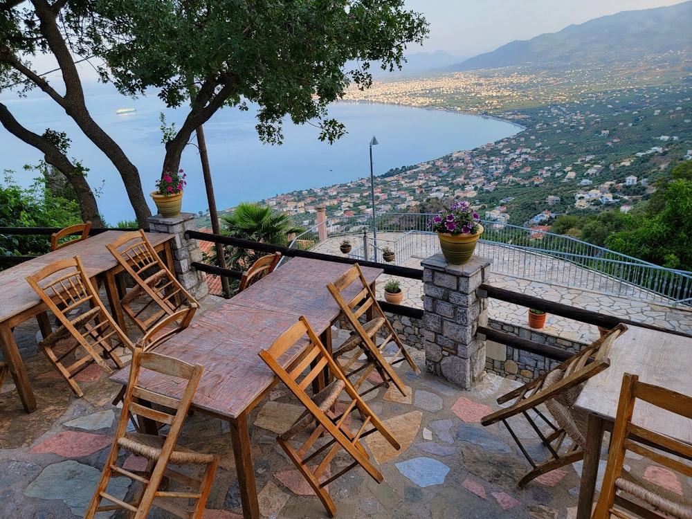 a table and chairs on a patio overlooking a body of water