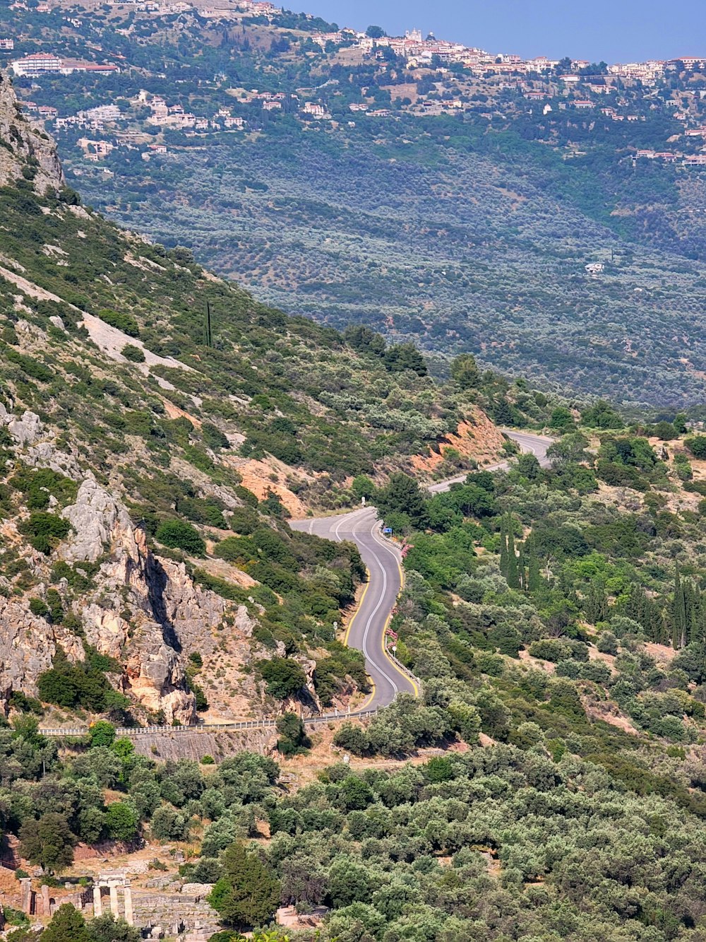 a winding road in the middle of a mountainous area