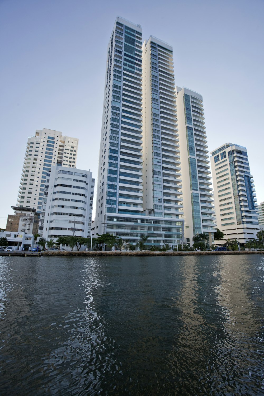 a body of water with a bunch of tall buildings in the background