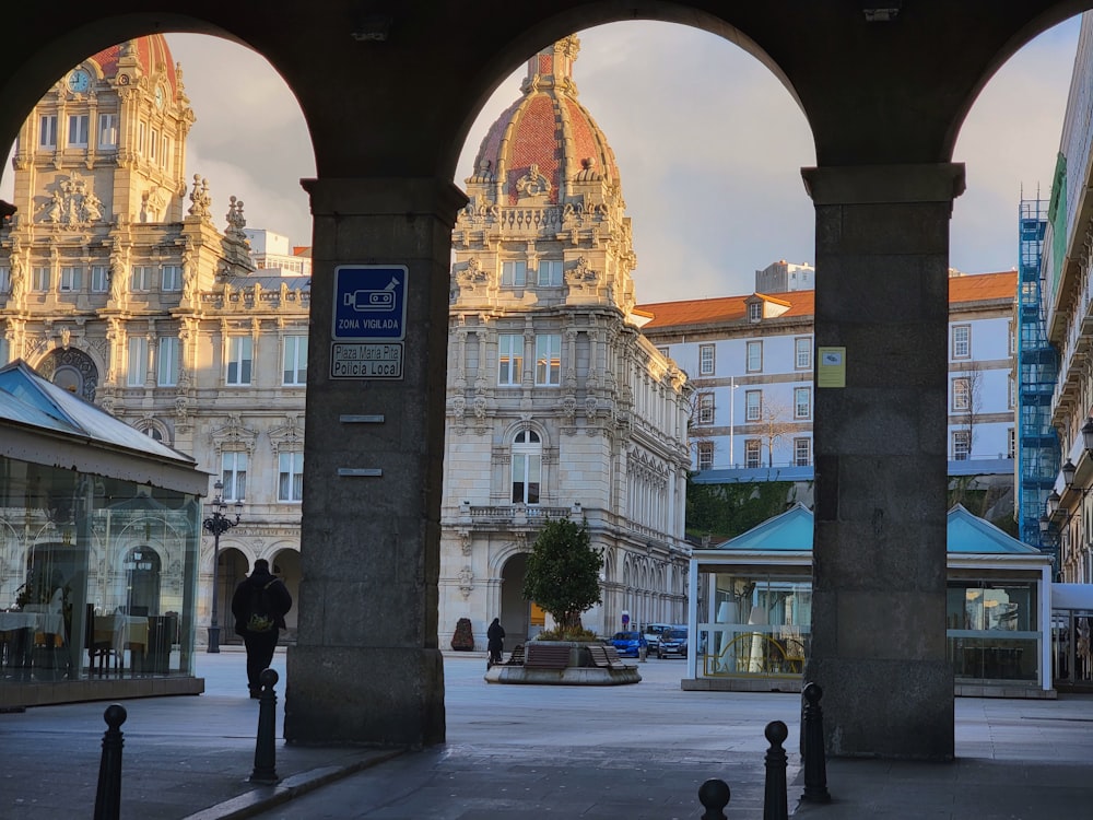 a couple of people that are standing in front of some buildings