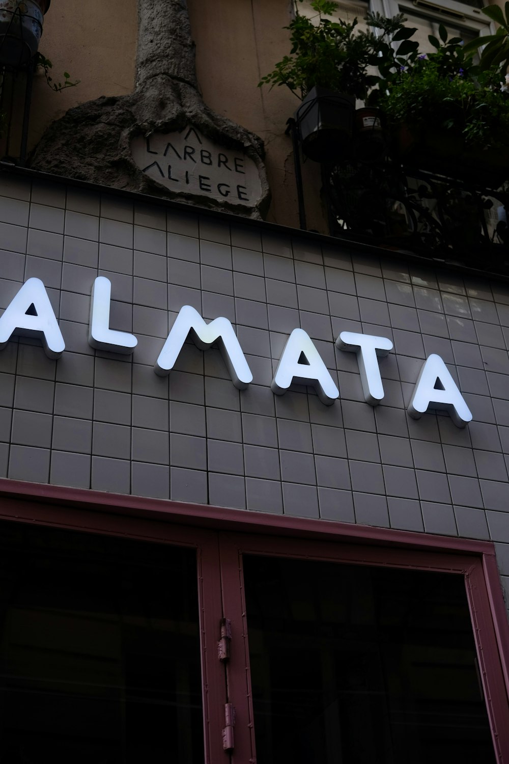 a sign on the side of a building that says almaata