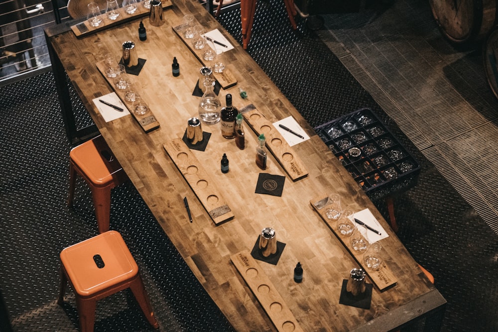 a wooden table topped with lots of bottles of wine