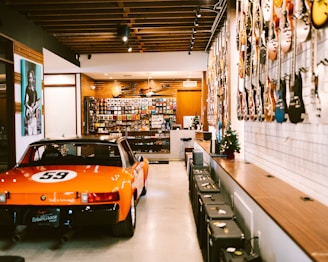 an orange sports car is parked in a store