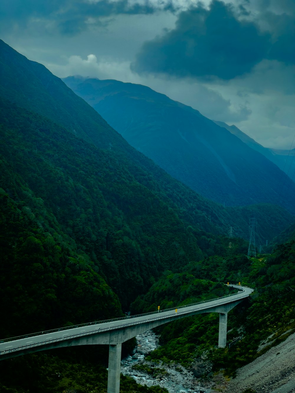 a highway going through a valley with mountains in the background