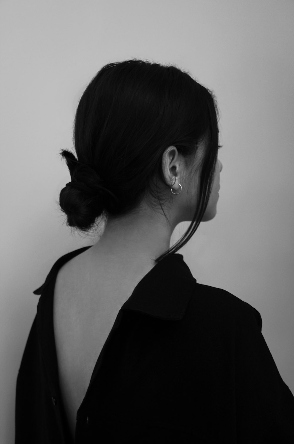 a woman in a black shirt with a bow in her hair