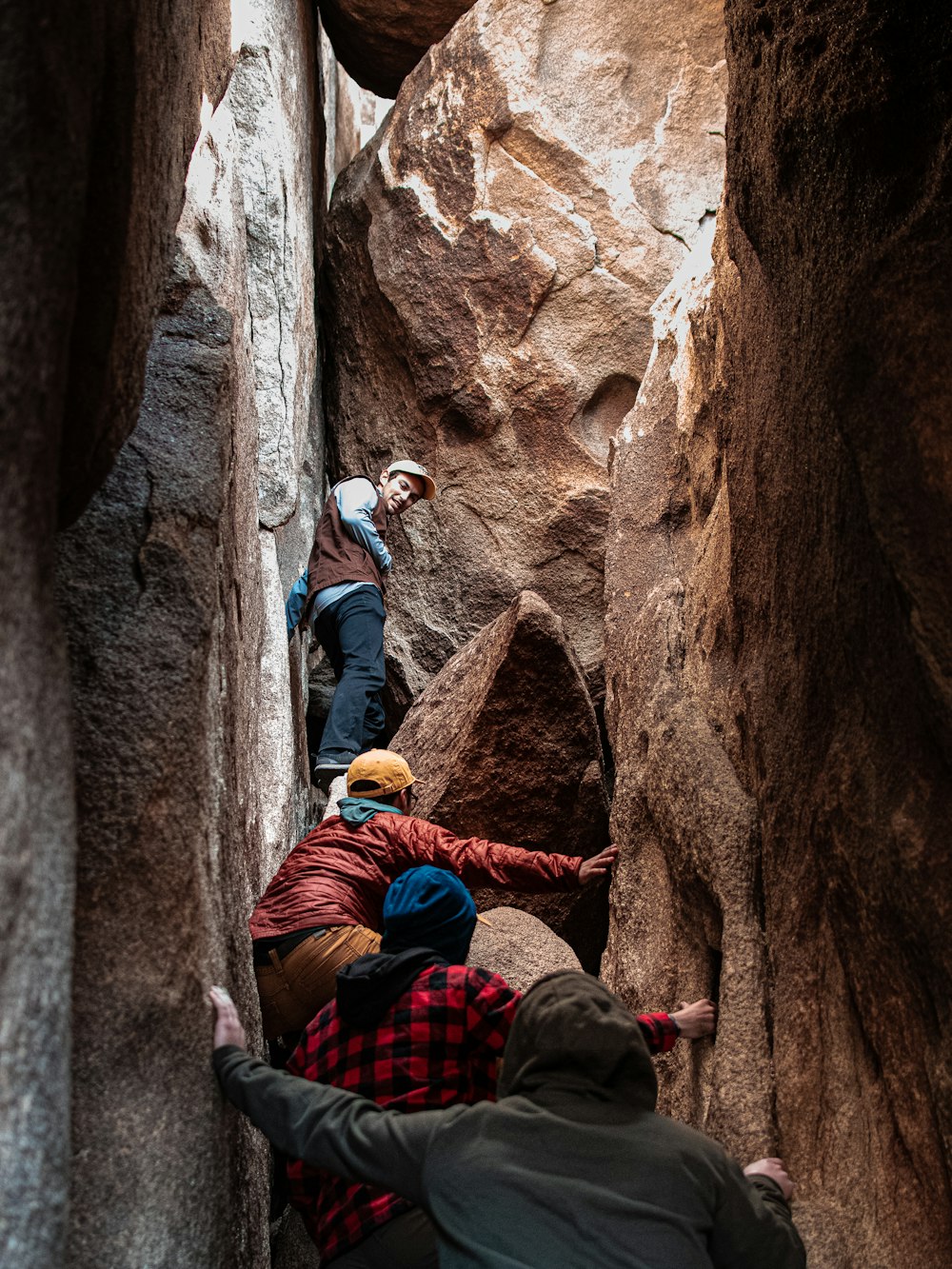 a group of people climbing up the side of a mountain