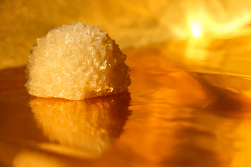 A serene golden-hued crystal arrangement glowing softly in natural light.