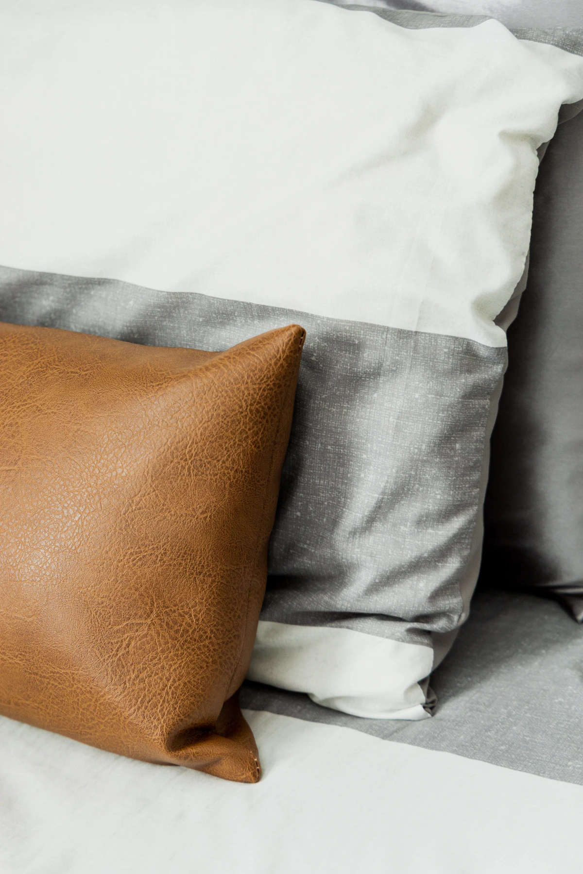 Layered pillowcases and bed pillows showing contrasting textures and finishes