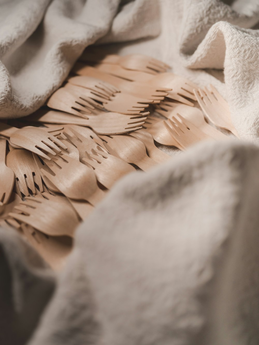 a close up of a bed with a white blanket