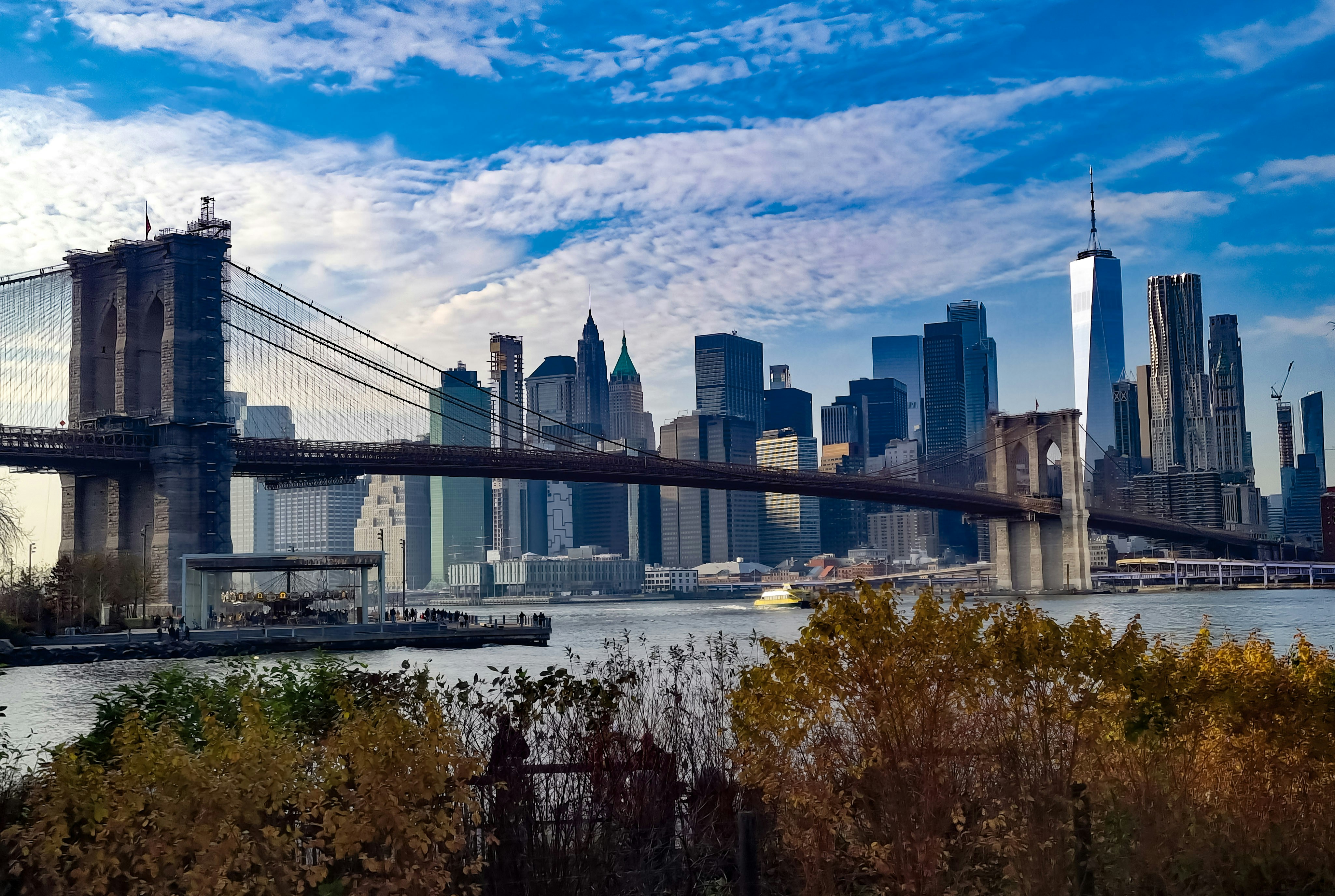 a view of a city skyline with a bridge in the foreground