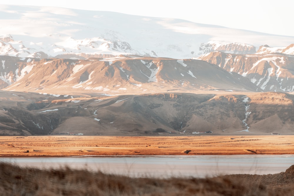 a mountain range with a body of water in the foreground