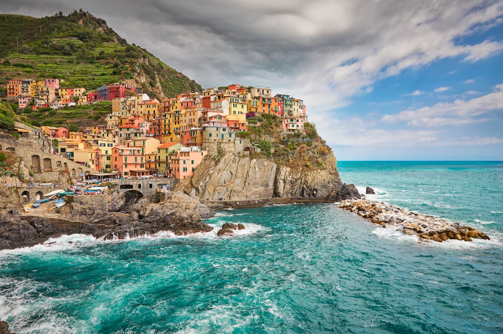 a view of a village on a cliff above the ocean