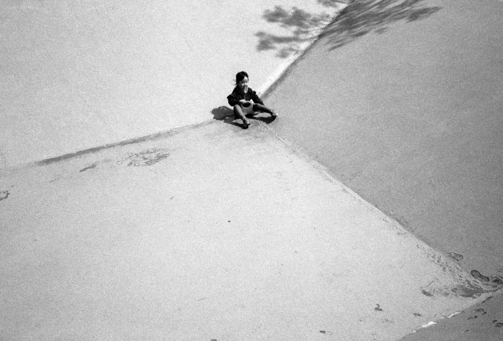 a black and white photo of a person on a snowboard