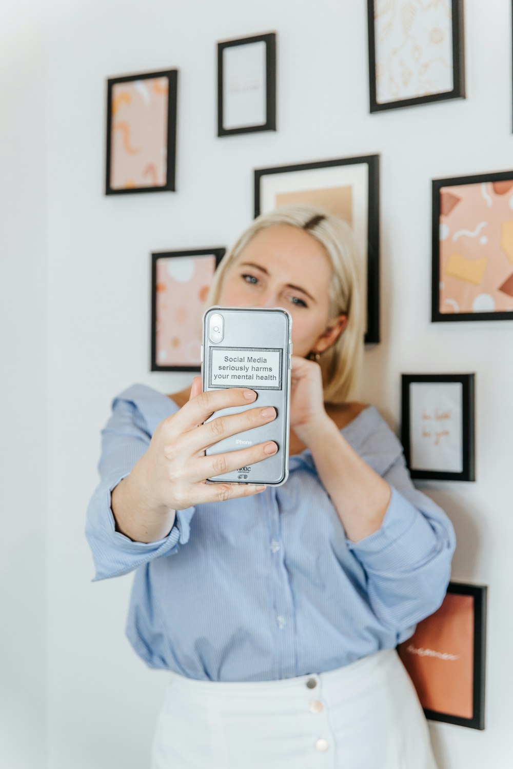 a woman holding a cell phone up to her face