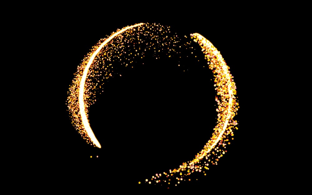 a circle of gold sparkles against a black background