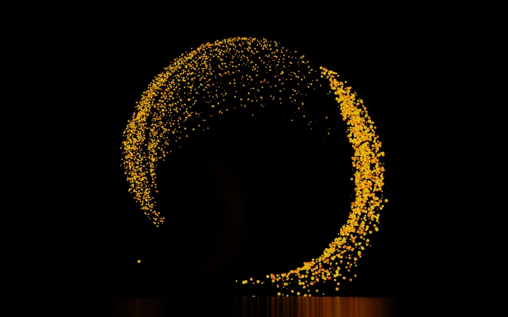 a black background with a circle made of yellow speckles