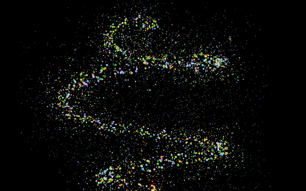 a black background with a spiral of colored confetti