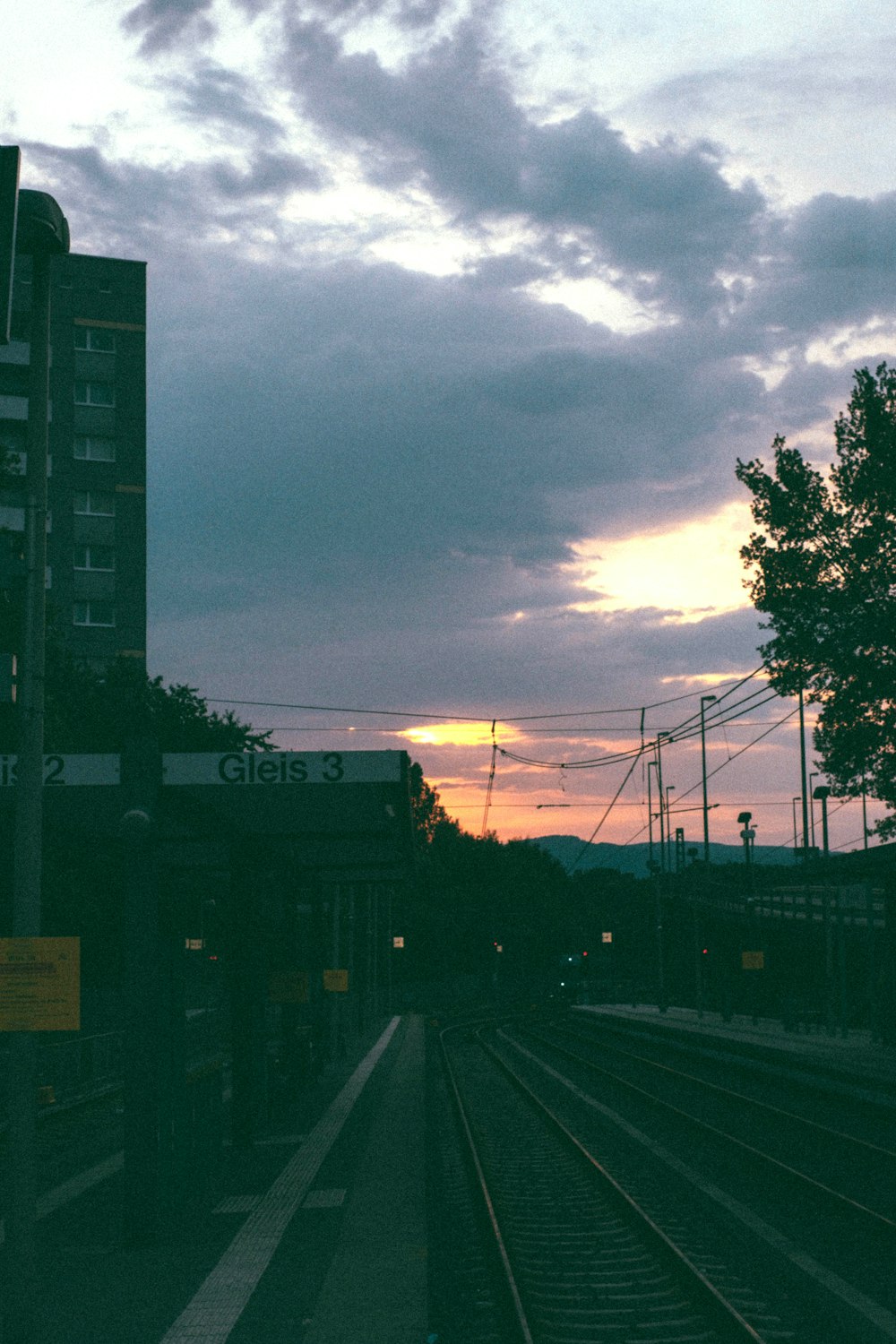 a train track with a building in the background