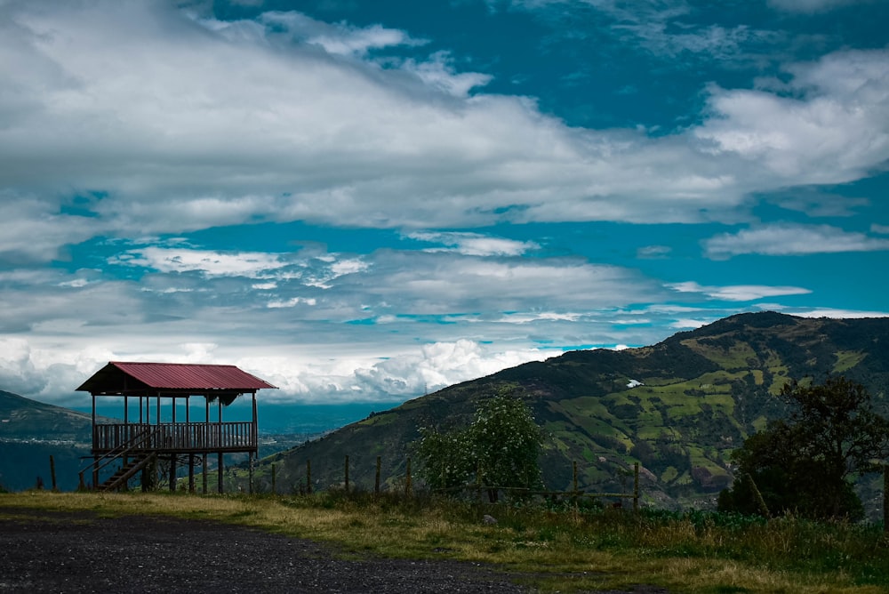 a small wooden structure on top of a hill