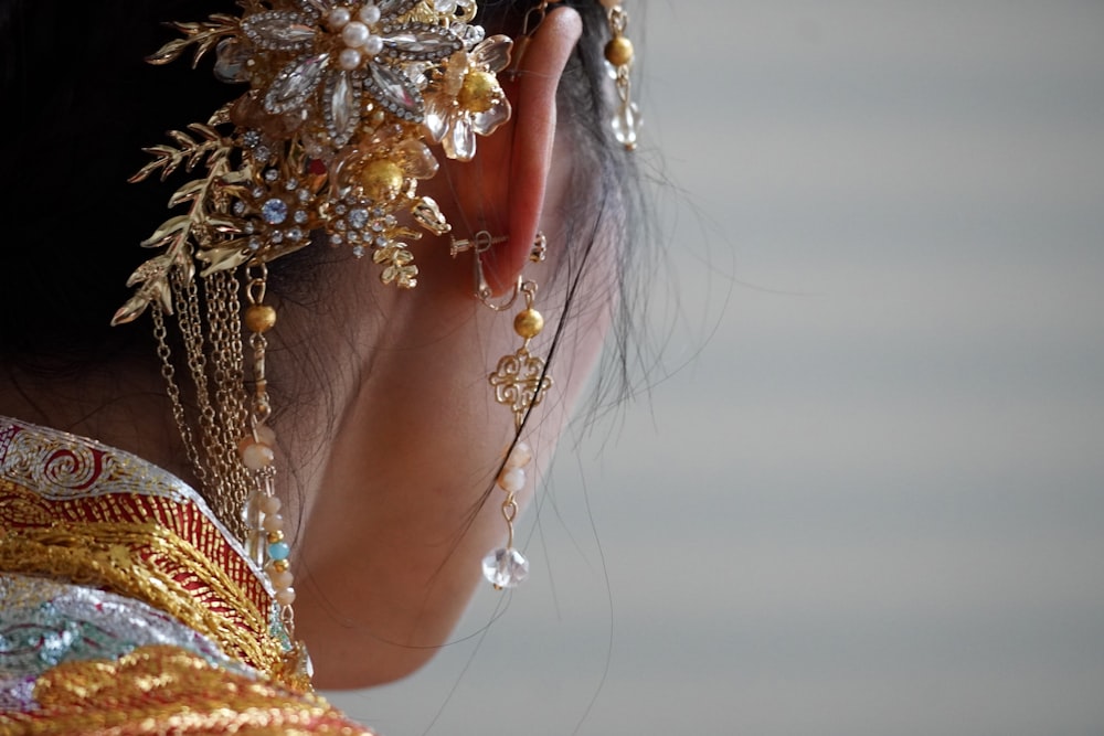 a close up of a person wearing a head piece