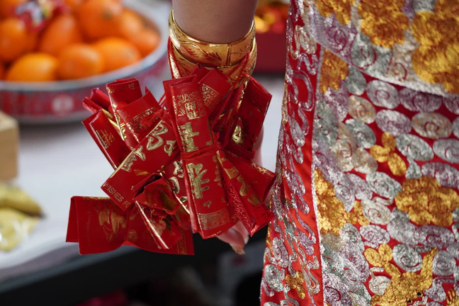 Close-up of colorful Chinese-style songjin brocade purses arranged on a wooden table.