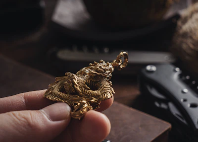 A close-up of a young protagonist with expressive eyes, holding a glowing, golden dragon scale.