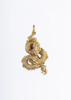 A majestic golden dragon coiled elegantly against a dark, mysterious background with shimmering gold accents.