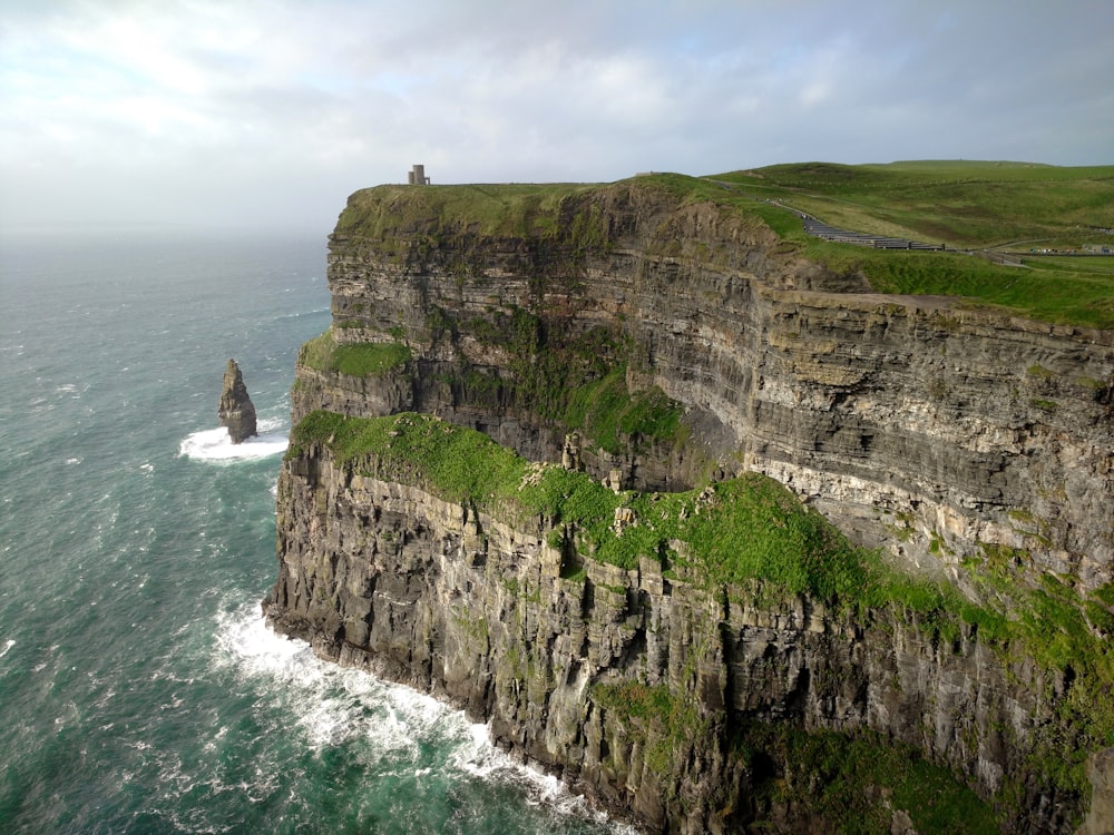 an aerial view of a cliff with a lighthouse on top of it