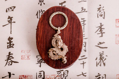 Close-up of a limited-edition branded keychain with intricate Chinese calligraphy details
