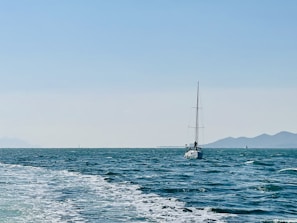 A sailboat navigating through the waves.