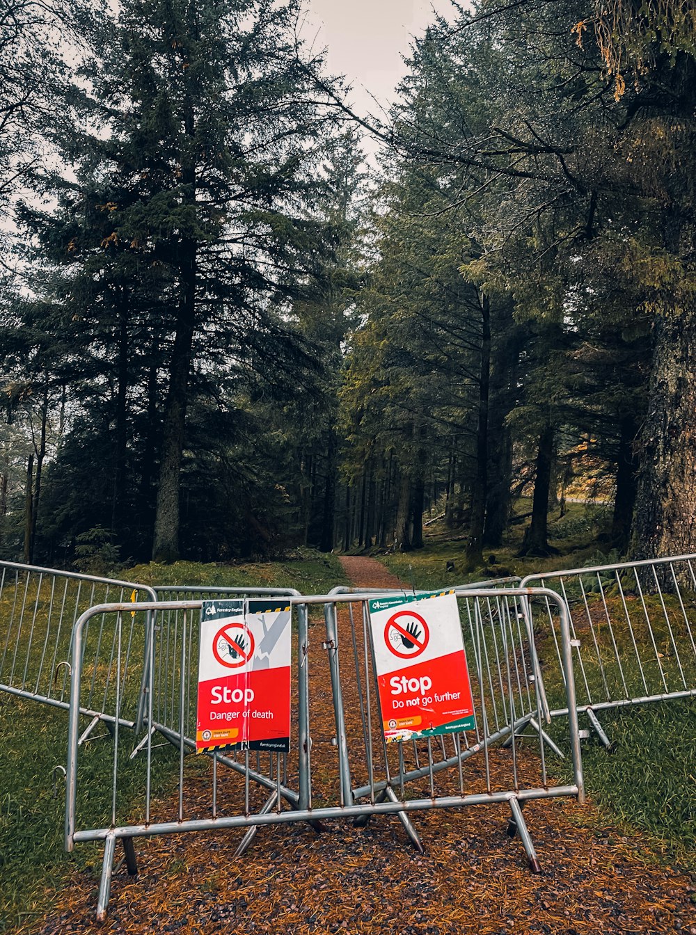 a metal barricade with two signs on it