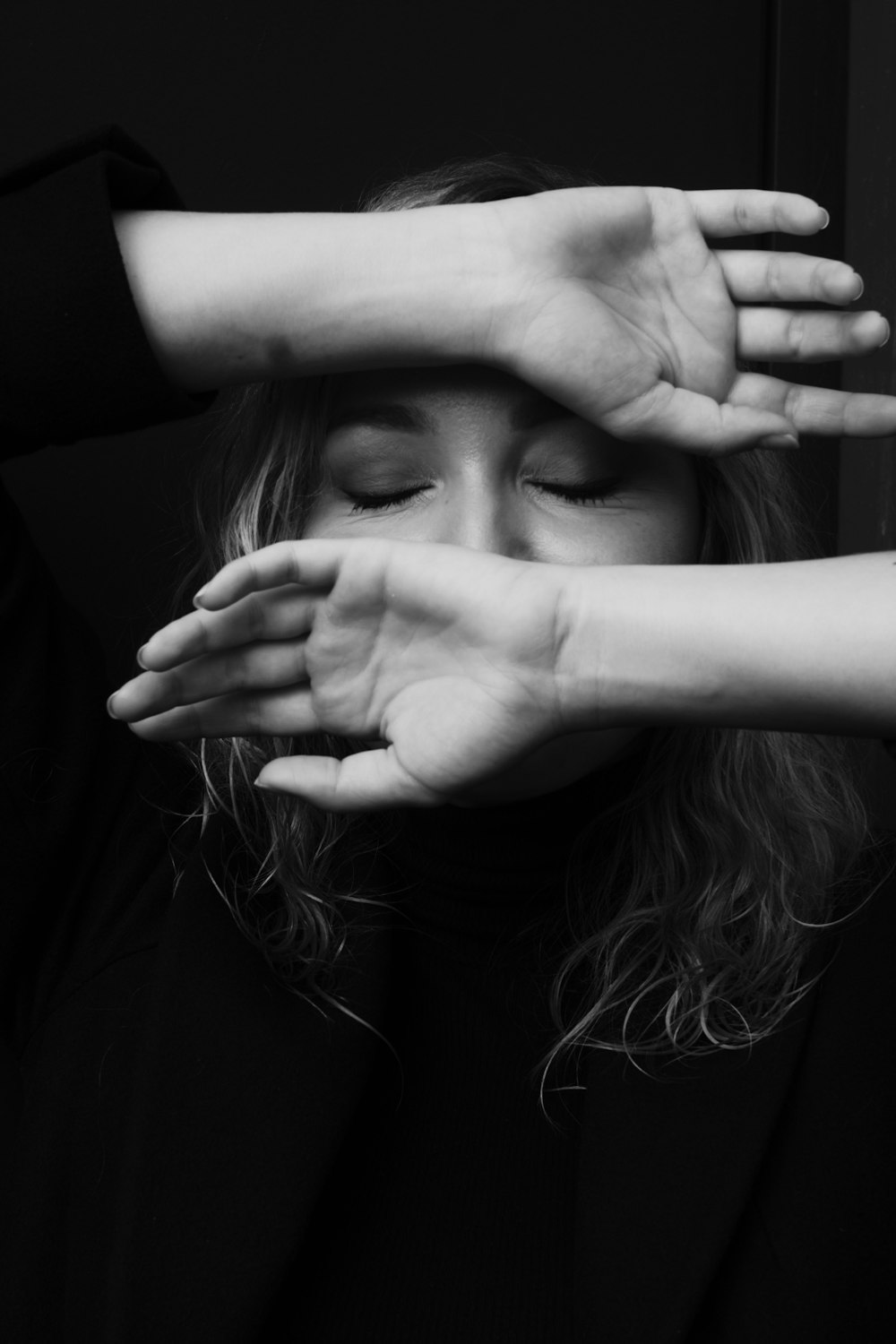 a woman covering her eyes with her hands