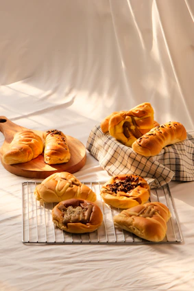 Freshly baked artisan bread and pastries displayed on a rustic wooden board