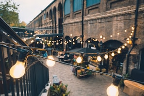 A bright outdoor space with decorative lighting and furniture.
