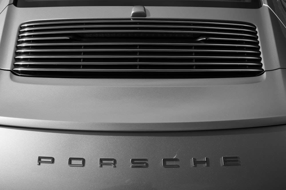 a close up of a porsche logo on a car