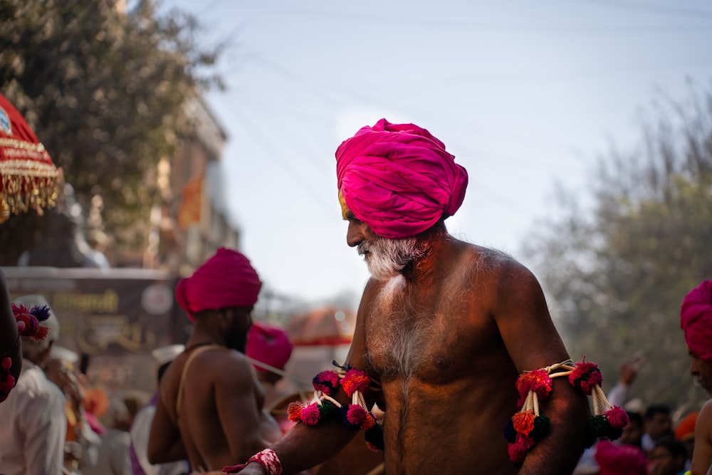 a man with a pink turban and a beard
