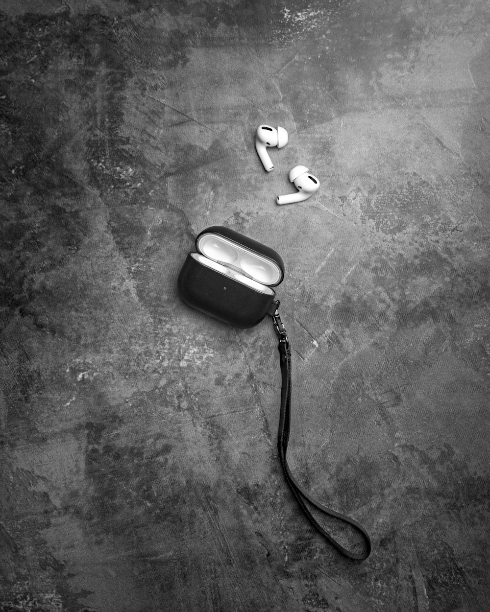 a black and white photo of a pair of ear buds