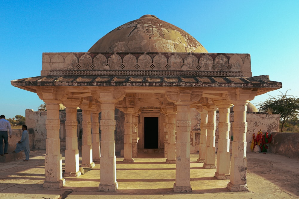 a building with pillars and a dome on top of it