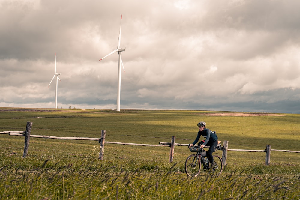 a man riding a bike down a lush green field