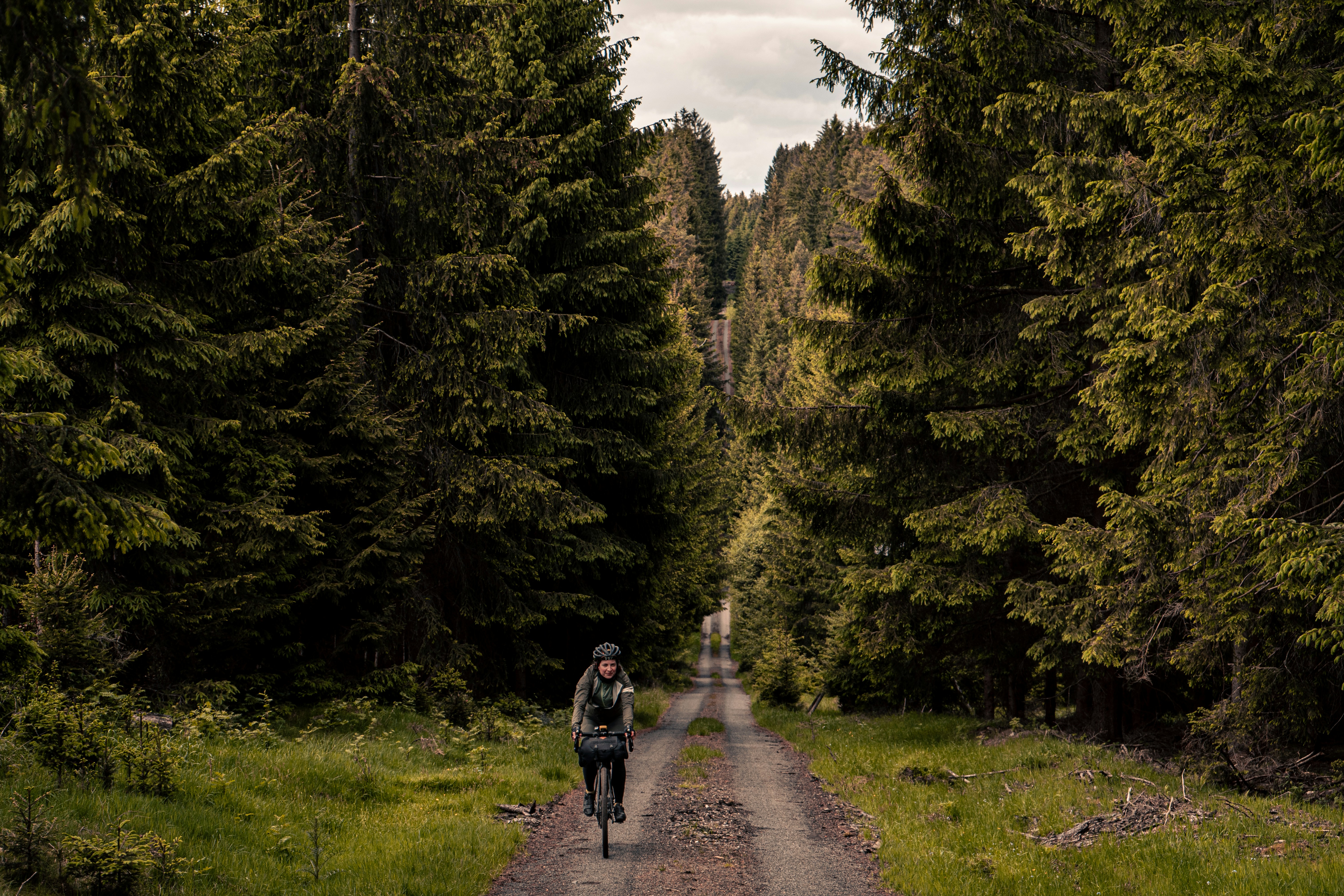 a person riding a bike down a dirt road
