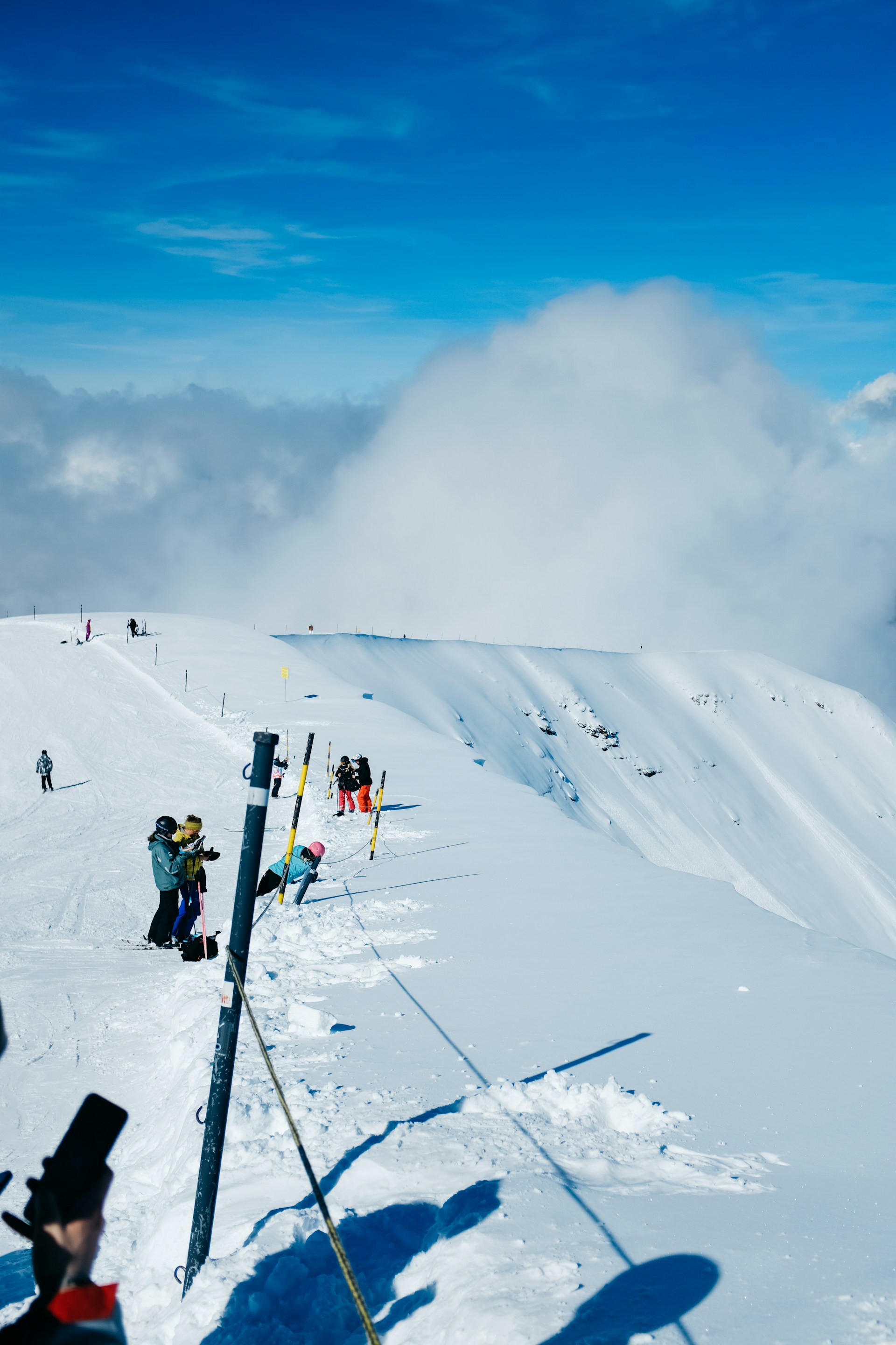 a group of people standing on top of a snow covered slope