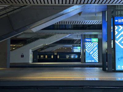 Digital LED screens showcasing advertisements on platforms at New Delhi railway station