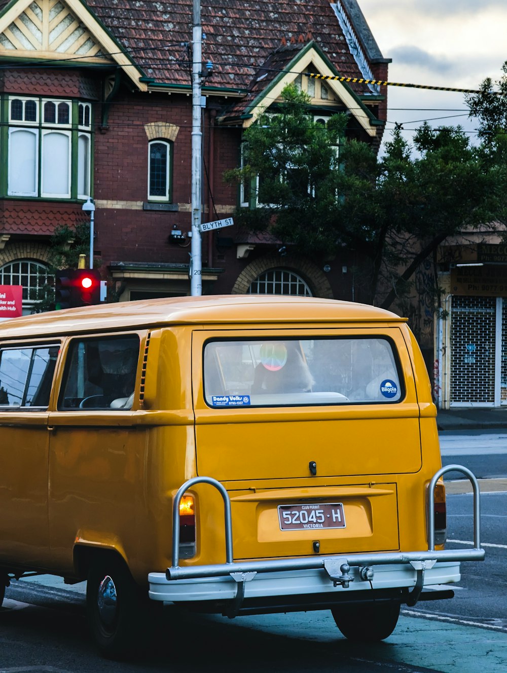 a yellow van is driving down the street