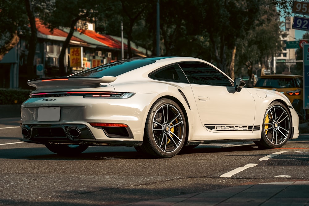 a white sports car parked on the side of the road