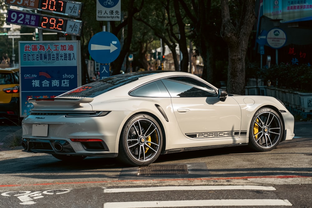 a white sports car parked on the side of the road