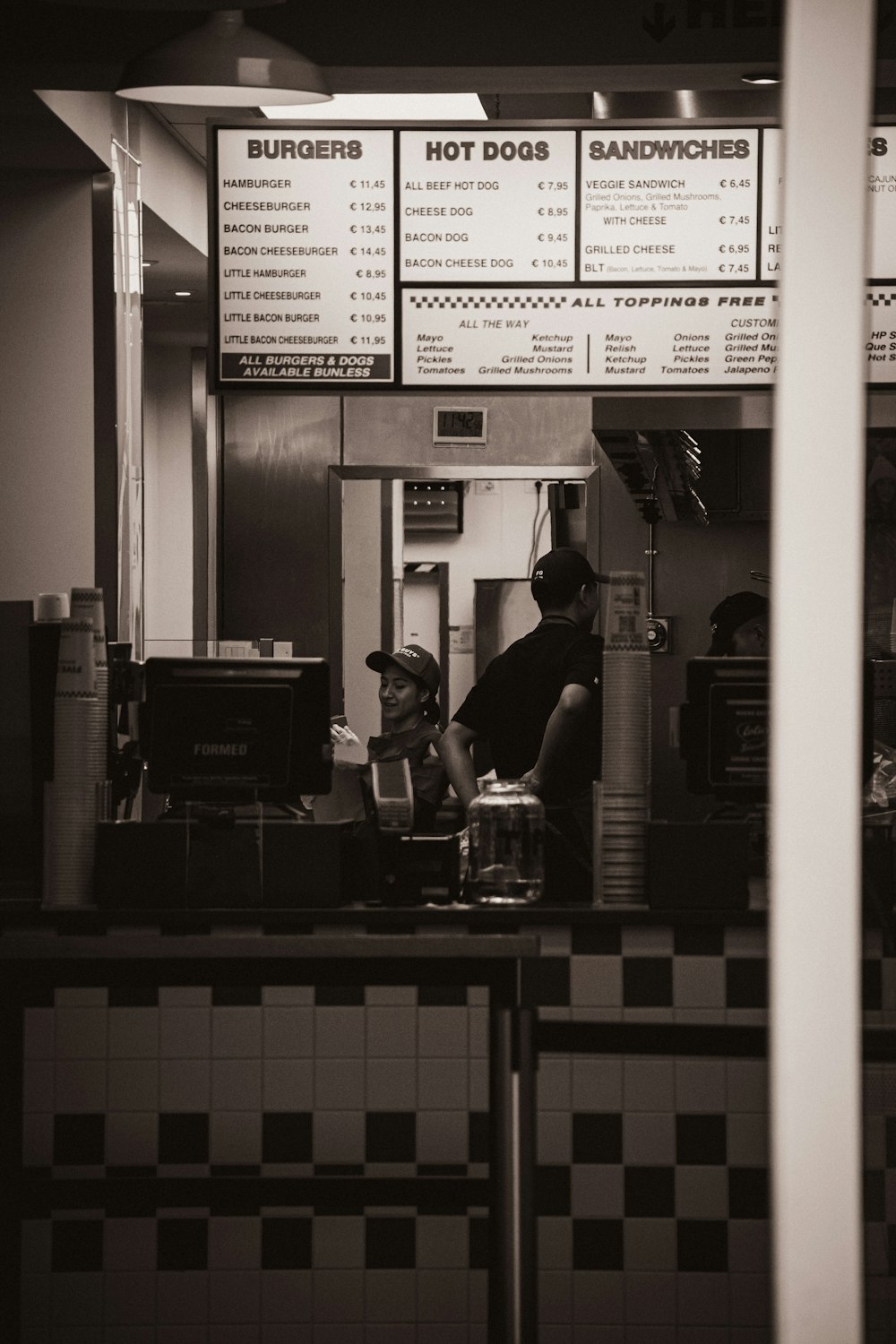 a man and a woman working in a restaurant kitchen