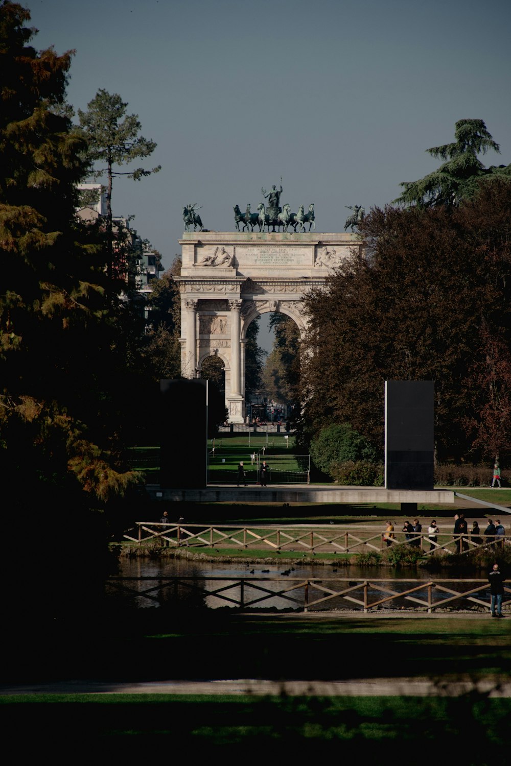 a view of a park with a statue in the background